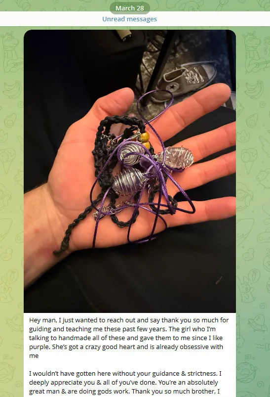Telegram message from Andrew with a photo of his hand holding handmade purple bracelets. He writes that the girl he's talking to made them for him, and thanks Jon for his guidance and strictness.