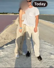 Telegram message from Harrison with a photo of him and a woman on a beach; her face is blurred